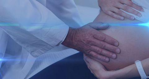 Biracial Doctor Performing Prenatal Checkup on Pregnant Woman