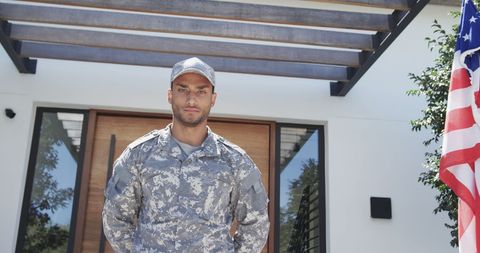 Proud Military Soldier Standing at Home with American Flag - Download Free Stock Images Pikwizard.com