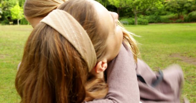 Mother Joyfully Embracing Daughter in Sunny Park - Download Free Stock Images Pikwizard.com