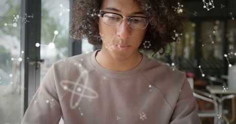 Curious Scientist Analyzing Molecular Patterns in Modern Café Setting