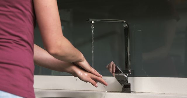 Person Washing Hands Under Kitchen Faucet Pouring Water - Download Free Stock Images Pikwizard.com