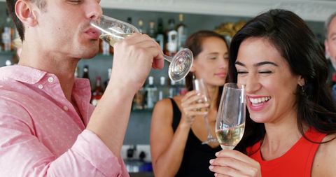 Joyful Friends Celebrating with Champagne in Restaurant