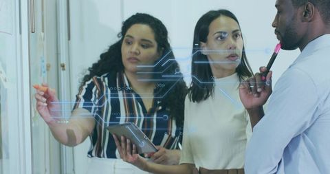 Diverse team collaborating on digital whiteboard with innovative technology