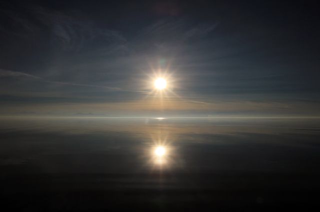 Serene Sunrise Reflecting Over Calm Ocean Waters - Download Free Stock Photos Pikwizard.com