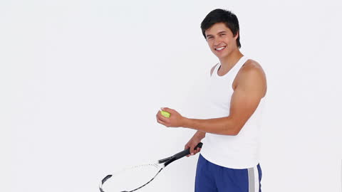 Smiling Tennis Player Practicing Indoors with Racket