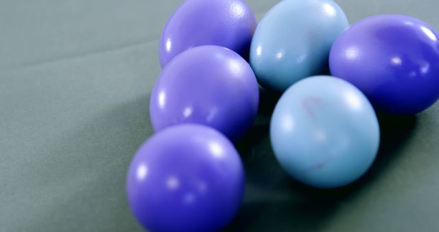 A collection of blue and purple Easter eggs are arranged on a surface, with copy space - Download Free Stock Photos Pikwizard.com