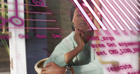 Pensive Woman Surrounded by Graphs and Code Projecting on Glass