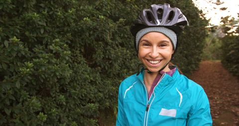 Cheerful Female Cyclist Enjoying Forest Ride