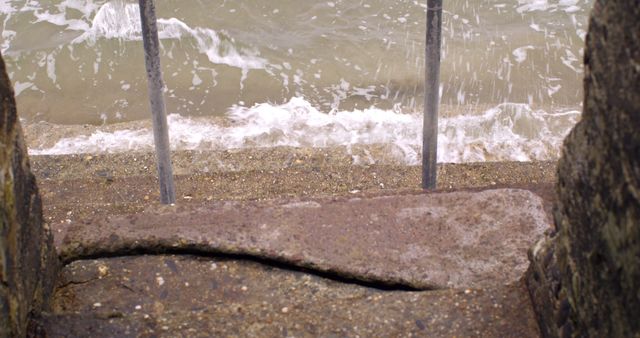 Waves Crashing Against Seaside Pier with Iron Railing - Download Free Stock Images Pikwizard.com