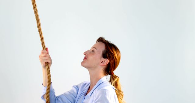 Woman Holding Rope Looking Up with Determination - Download Free Stock Images Pikwizard.com