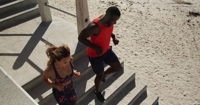 Fitness Enthusiasts Running on Beach Stairs for Workout - Download Free Stock Images Pikwizard.com