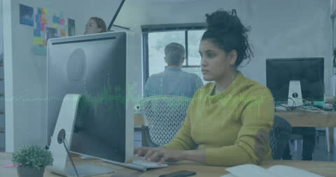 Focused Businesswoman Analyzing Data on Computer