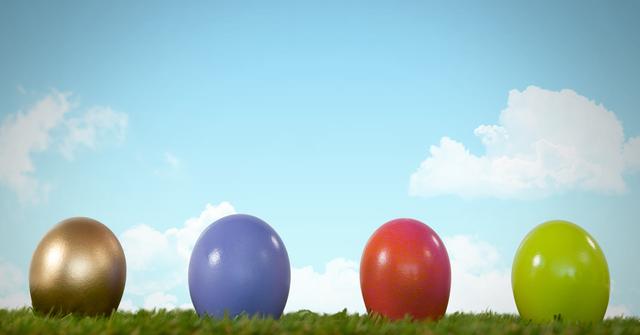 Colorful Easter eggs sit on green grass with a bright blue sky and white clouds in the background. Perfect for Easter-themed content, greeting cards, advertisements, and holiday decorations.