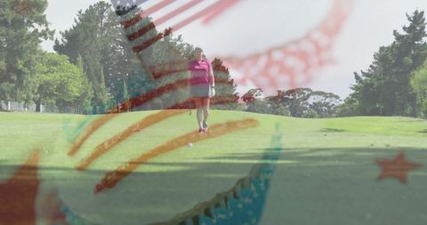 Female golfer walking fairway with club in hand