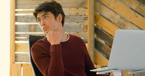 Young professional deep in thought at modern office