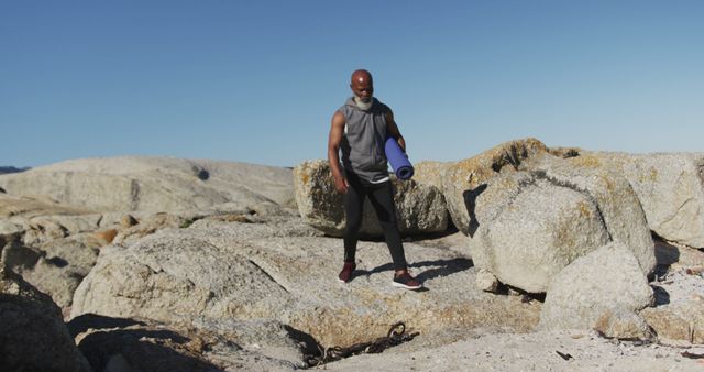 Active Senior Man Hiking With Yoga Mat On Rocky Terrain - Download Free Stock Images Pikwizard.com