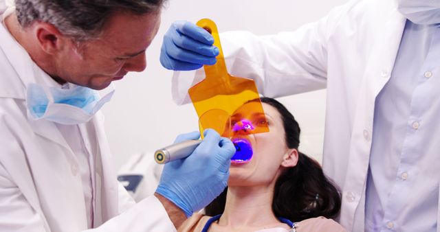 Dentists Using UV Light for Dental Treatment on Female Patient - Download Free Stock Images Pikwizard.com