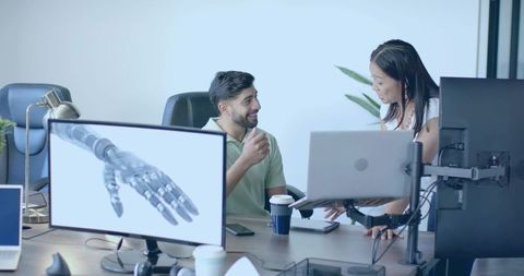 Tech Team Discussing Robotics Innovation in Modern Workspace