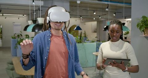 African American Coworkers Testing VR Headset in Collaborative Open-Plan Office