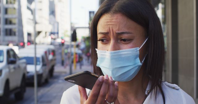 Concerned Woman Wearing Mask Using Phone in Urban Street - Download Free Stock Images Pikwizard.com