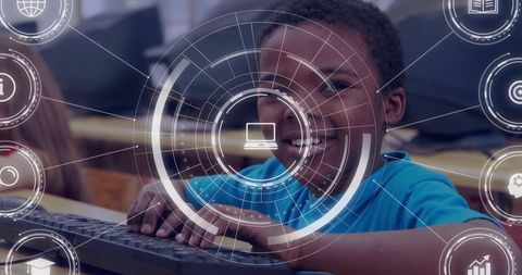 Boy typing on keyboard in classroom while engaging with futuristic digital hud interface