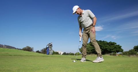Caucasian Golf Player Lining Up Putt on Scenic Golf Course - Download Free Stock Images Pikwizard.com