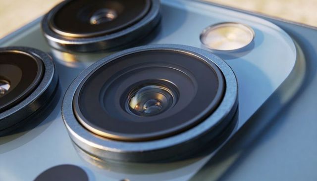 Macro smartphone camera lens close-up showing triple lens, metal rings and led flash
