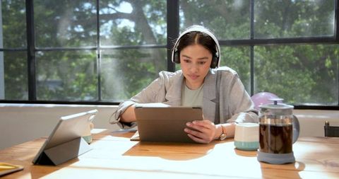 Focused Professional Using Tablet Headphones Office Environment