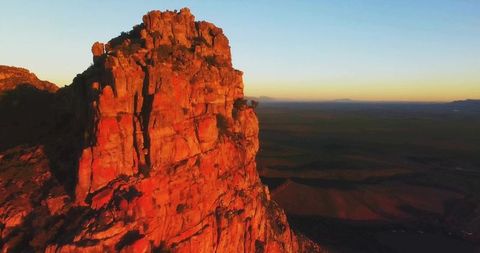 Sunrise on Majestic Red Sandstone Cliff in Desert Landscape
