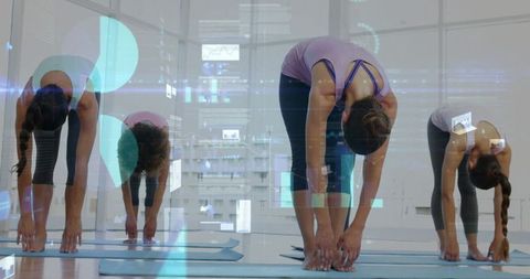 Women Practicing Forward Fold Yoga in Urban Studio Reaching Floor with HUD Overlay