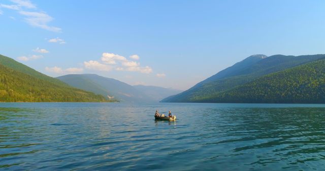 Peaceful Lake with Boat, Forested Hills, and Blue Sky - Download Free Stock Images Pikwizard.com