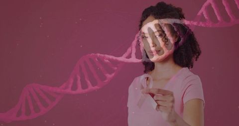 Holding pink ribbon with dna helix promoting breast cancer genetics awareness and advocacy