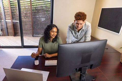Diverse coworkers collaborating in a modern home office environment