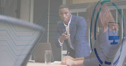 Confident businessman discussing tech strategy in modern office