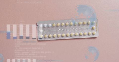 Contraceptive Pills Packaging with Digital Data Overlay on Pink Background