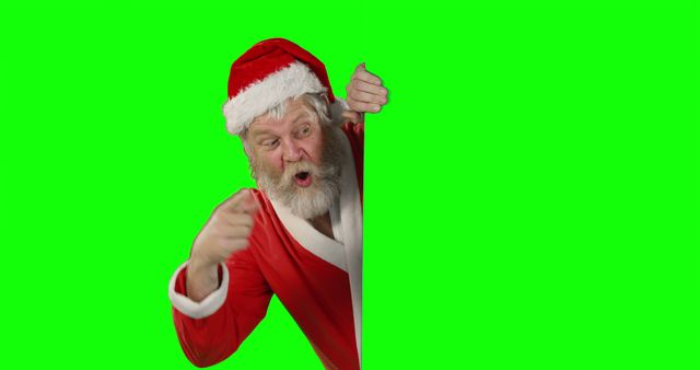 Elderly man dressed as Santa Claus peeking around a green screen background, appearing surprised and animated. Suitable for use in holiday advertisements, Christmas greeting cards, festive promotions, and winter-themed projects. The green screen background allows for easy editing and insertion into various holiday settings.