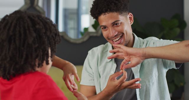 Father And Daughter Communicating Using Sign Language At Home - Download Free Stock Images Pikwizard.com