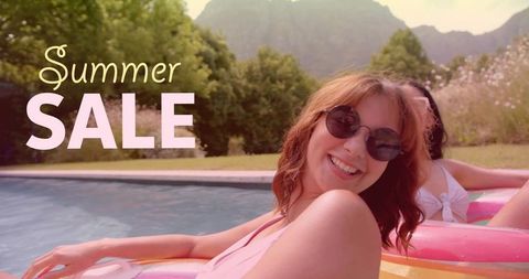 Smiling woman lounging on bright inflatable float by pool with summer sale overlay