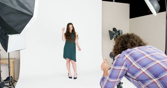 Photographer capturing female model in studio with professional equipment - Download Free Stock Images Pikwizard.com