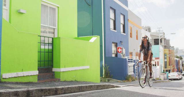 Woman Cycling Down Quaint Colorful Street - Download Free Stock Images Pikwizard.com