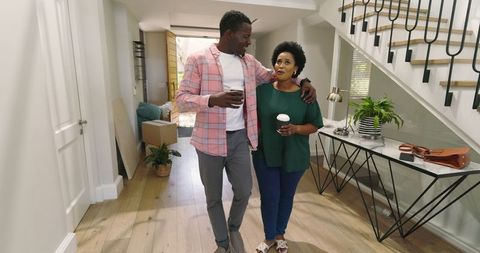 Joyful African American Couple Drinking Coffee in New Home