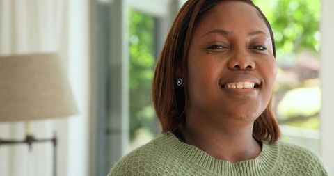 Smiling Woman Relaxing in Modern Living Room
