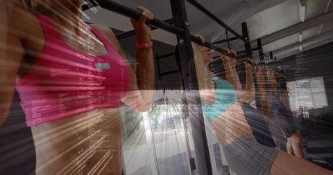 Group performing pull-ups on metal rig in gym with motion blur and digital data overlay