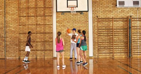 High School Basketball Team Practicing on Indoor Court