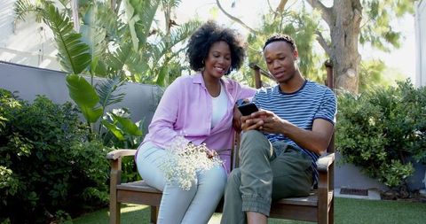 Smiling Couple Taking Selfie in Beautiful Garden