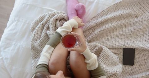 Woman Relaxing with Tea in Cozy Home Atmosphere
