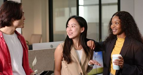 Diverse team having friendly discussion in modern office