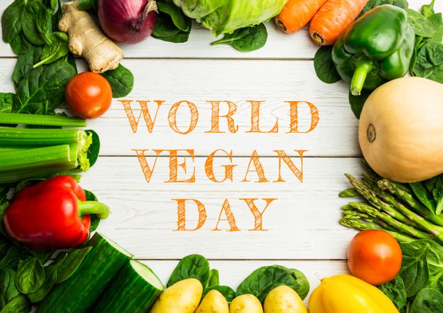 This image features a variety of fresh vegetables arranged in a circle on a white wooden background with text in the center celebrating World Vegan Day. Perfect for use in marketing materials, blog posts, healthy lifestyle promotions, vegan event advertisements, and social media campaigns highlighting veganism and plant-based eating.