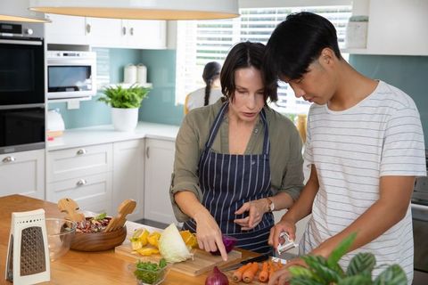 Diverse family cooking together in bright kitchen