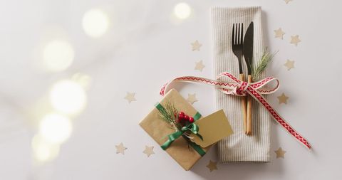 Elegant Christmas Table Setting with Gift, Pine, and Gold Stars - Download Free Stock Images Pikwizard.com
